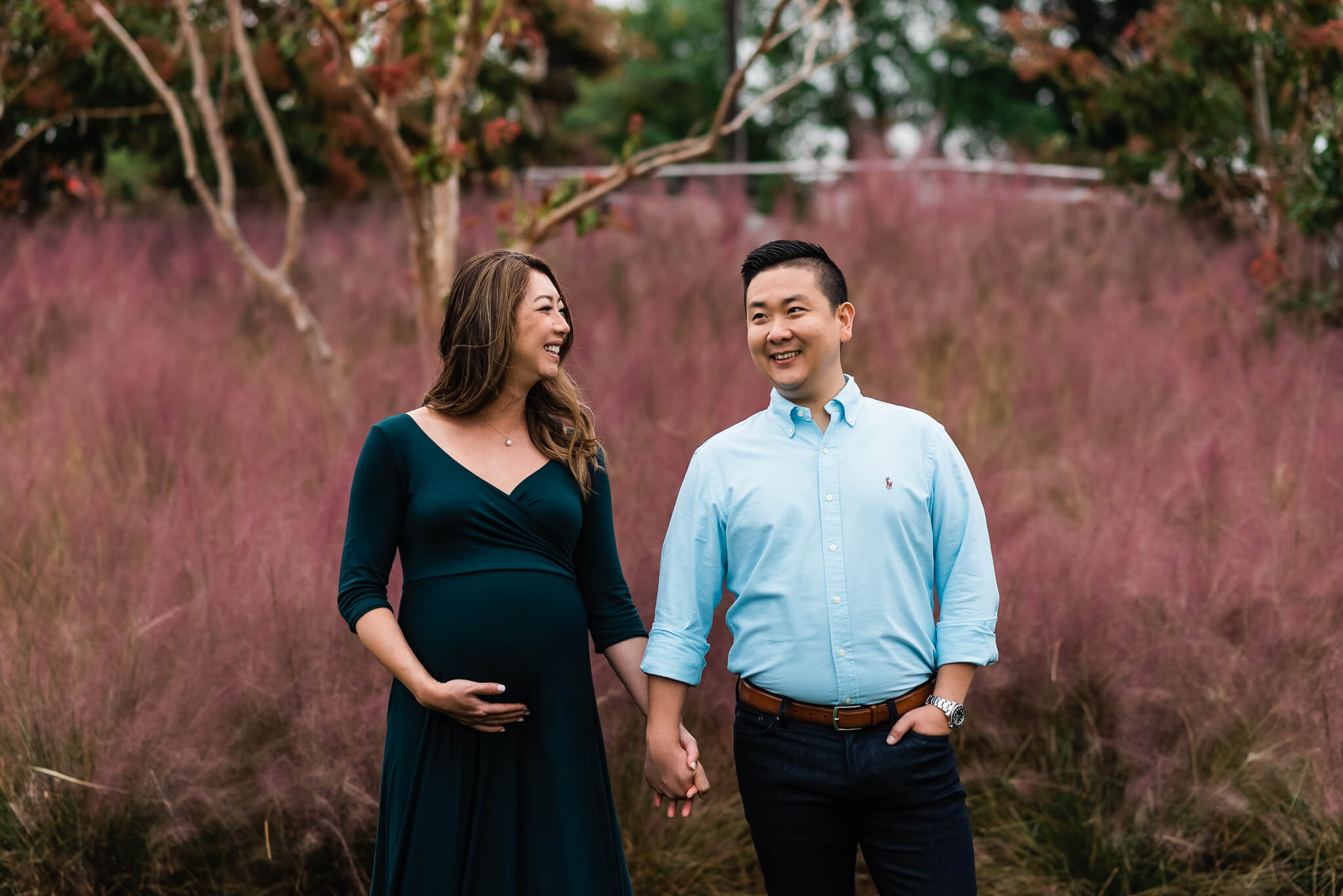 expecting mama wearing spruce green maternity gown holding her husband's hand, Northern Virginia Obstetricians