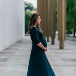 mama holding her baby bump in a dark green gown, Northern Virginia Obstetricians
